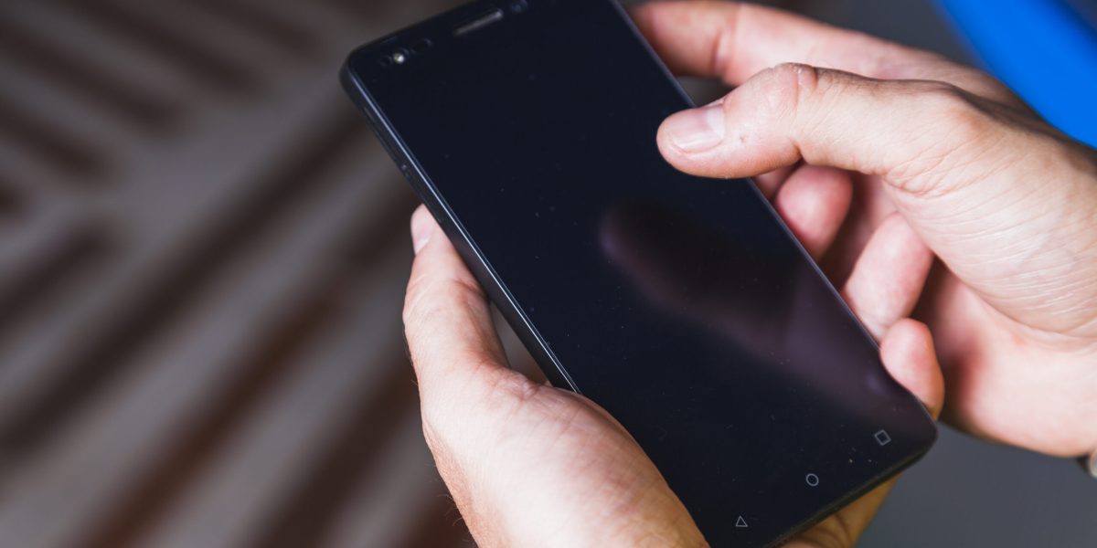 from-hand-using-smartphone-scaled.jpg - JurnalUrban