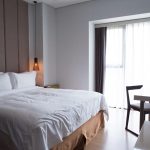 hotel-bedroom-with-double-bed-table-tv-set-scaled.jpg - JurnalUrban