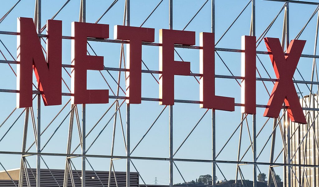In an aerial view, the Netflix logo is displayed above Netflix corporate offices.