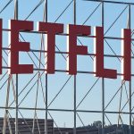 In an aerial view, the Netflix logo is displayed above Netflix corporate offices.