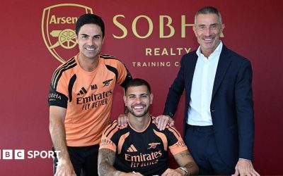 New Arsenal signing Bruno Guimaraes poses for a photograph with manager Mikel Arteta and sporting director Andrea Berta